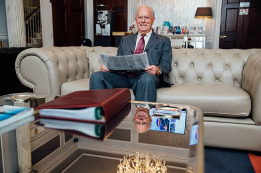 Dr Zybutz sitting reading the paper on a couch